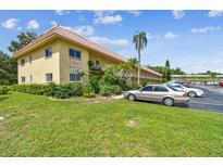 Charming condo complex with lush landscaping, visible parking and a vibrant, sunny exterior at 2003 Greenbriar Blvd # 8, Clearwater, FL 33763