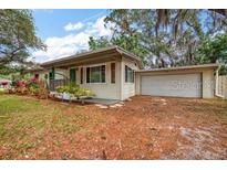 Charming single-story home with a well-manicured lawn and attached two-car garage at 2316 Lancaster Dr, Clearwater, FL 33764