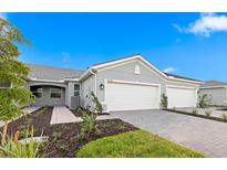 Beautiful single Gathering home with a neutral paint scheme, 2-car garage, and manicured landscaping at 27132 Capri Shores Cir, Englewood, FL 34223