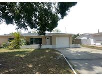 Charming single-story home featuring an attached garage and well-lit exterior at 4374 32Nd N Ter, St Petersburg, FL 33713