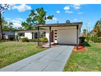 Charming single-story home featuring a carport, landscaped yard and a freshly painted exterior at 4379 Porpoise Se Dr, St Petersburg, FL 33705