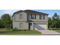 Two-story home boasts a modern exterior with gray siding and a two-car garage at 5676 Red Kite Dr, Wimauma, FL 33598