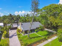 Charming single-Gathering home featuring a screened porch, mature trees, and well-manicured lawn, creating a tranquil setting at 859 Patterson Dr, Sarasota, FL 34234