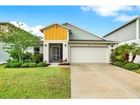 Charming single-Gathering home featuring a well-manicured lawn and two-car garage at 13111 Fruitville Way, Riverview, FL 33579