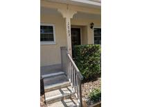 Inviting home entrance with neat landscaping, a well-lit porch, and clear house number display at 2465 Northside Dr # 1703, Clearwater, FL 33761