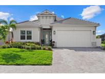 Charming home with a well-manicured lawn, light-colored siding, and a two-car garage at 271 Monet Trl, Bradenton, FL 34212