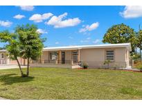 Charming single-story home with a well-maintained lawn and landscaping at 4414 W Hanna Ave, Tampa, FL 33614