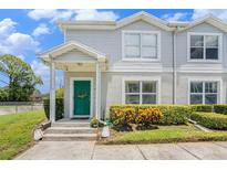 Charming townhome featuring a welcoming green front door and neat landscaping at 5501 67Th N Ave # 11, Pinellas Park, FL 33781