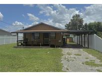 Charming single-story home featuring a covered porch, carport, and a compact front yard at 5807 N Hale Ave, Tampa, FL 33614