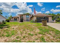 Stunning single Gathering home with a large front yard and an American flag at 6123 India Dr, Spring Hill, FL 34608