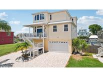 Stunning multi-story home with ample parking and water views, including multiple decks and a front yard at 6543 Louise Ct, Hudson, FL 34667