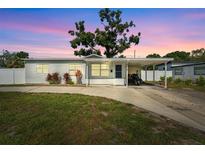 Charming single-story home with a covered carport and well-maintained front yard at 7210 14Th N St, St Petersburg, FL 33702