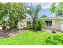Single-story home featuring a well-maintained lawn, mature landscaping, and charming curb appeal at 113 Maplewood Ave, Clearwater, FL 33765