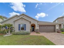 Charming home with brick walkway, two-car garage, well-manicured lawn, and appealing curb appeal at 11327 Brighton Knoll Loop, Riverview, FL 33579