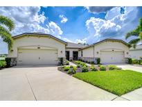 Charming single-story home featuring a well-manicured lawn and a triple car garage at 11619 Cambium Crown Dr, Riverview, FL 33569