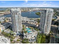 Stunning aerial view of luxury condo towers with pool and city skyline backdrop on a sunny day at 1209 E Cumberland Ave # 604, Tampa, FL 33602