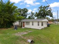 Charming single-story home featuring a cozy front porch, a well-maintained lawn, and a classic design in a quiet neighborhood at 12324 Pittsfield Ave, Tampa, FL 33624