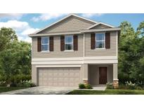 Charming two-story home with neutral siding, shutters and a two car garage at 13245 Tropical Breeze Way, Hudson, FL 34669