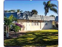 Quaint single story home featuring a well-manicured lawn and decorative palm trees for a charming curb appeal at 1802 Bedford Ter # 170, Sun City Center, FL 33573
