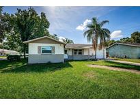 Charming single-story home featuring a front lawn and a one car garage at 2003 Whispering Pines St, Largo, FL 33774