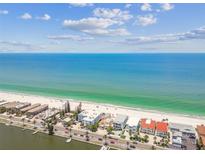 Stunning aerial view showcasing beachfront property with turquoise ocean and white sandy beach at 30 Gulf Blvd, Indian Rocks Beach, FL 33785