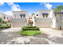 Inviting home exterior with white facade, two-car garage, and well-maintained landscaping at 3145 Lake Ellen Dr # 3145, Tampa, FL 33618