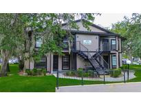 Inviting two-story apartment building featuring well-maintained landscaping and secure stairwell access at 4012 Tumble Wood Trl # 104, Tampa, FL 33613