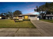 Charming single-story home featuring a well-manicured lawn and a two-car garage at 4085 105Th N Ave, Clearwater, FL 33762