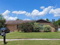 Charming single-story home with a well-maintained lawn and mature landscaping on a sunny day at 432 Flamingo Dr, Apollo Beach, FL 33572