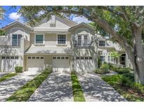 Charming townhouse with well-maintained landscaping, a two-car garage and a balcony at 5090 White Pine Ne Cir, St Petersburg, FL 33702