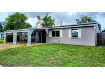 Charming single-story home with covered parking, well-maintained lawn, and neutral-toned exterior at 5221 82Nd N Ave, Pinellas Park, FL 33781
