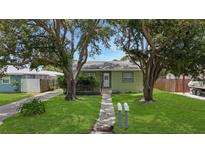 Charming single-story home with a well-maintained lawn and mature trees at 5725 18Th S Ave, Gulfport, FL 33707