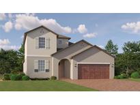 Charming two-story home with a brick driveway and manicured landscaping, perfect for curb appeal at 6611 Active Run, New Port Richey, FL 34653