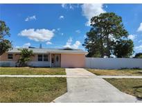 Charming single-story home with a well-maintained lawn, driveway and mature trees at 9161 56 Th, Pinellas Park, FL 33782
