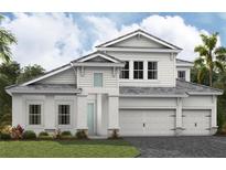 Inviting two-story home boasts a three-car garage, light gray roof, and well-manicured lawn at 10313 Longmeadow Ave, Parrish, FL 34219