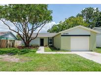 Charming single-story home with a well-maintained lawn, mature tree, and attached one car garage at 1040 Bridlewood Way, Brandon, FL 33511