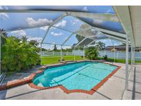 Screened in pool with brick trim, surrounded by greenery, offers a relaxing outdoor space at 10430 Crestfield Dr, Riverview, FL 33569
