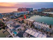 Beautiful aerial view of a townhouse complex near the beach with stunning views of the city and ocean at 120 Brightwater Dr, Clearwater Beach, FL 33767