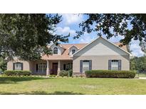 Charming single-story home with well-maintained lawn and landscaped front yard at 13122 Done Groven Dr, Dover, FL 33527