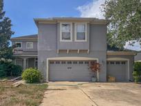 Charming two-story home with attached two-car garage and neutral toned stucco exterior at 16027 Vine Cliff Ave, Hudson, FL 34667