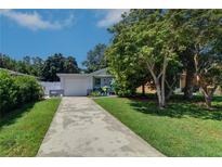 Charming single-story home with a well-maintained front lawn and mature trees at 3910 14Th N Ave, St Petersburg, FL 33713