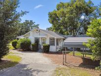 Charming home featuring well-maintained landscaping and a convenient carport at 5906 12Th St, Zephyrhills, FL 33542