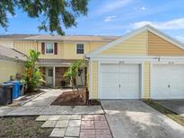 Charming townhome with a one car garage and well maintained front yard at 6114 Oak Cluster Cir, Tampa, FL 33634