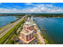 Stunning aerial view of condo buildings by the bay with a beautiful blue sky and lush greenery at 7430 Sunshine Skyway S Ln # 602, St Petersburg, FL 33711
