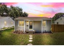 Charming single-story home featuring a well-manicured lawn and inviting front porch with decorative stepping stones at 744 53Rd N Ter, St Petersburg, FL 33703