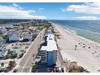 Stunning aerial view of Island Inn condo building by the beach, offering breathtaking coastal scenery at 9980 Gulf Blvd # 408, Treasure Island, FL 33706