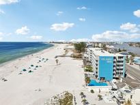 Island Inn hotel showcasing its prime beachfront location and pool amenities, set against a scenic coastline at 9980 Gulf Blvd # 408, Treasure Island, FL 33706