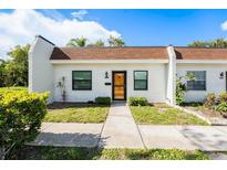 Charming single-story home featuring a well-maintained lawn, neutral color palette, and inviting entrance at 13710 Mission Oaks Blvd # 2A, Seminole, FL 33776