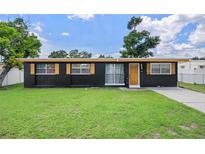 Charming single-story home featuring a well-maintained lawn, freshly painted exterior, and decorative shutters at 1707 Windsor Way, Tampa, FL 33619