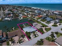 Beautiful waterfront property with a private boat dock and a stunning view of the ocean at 202 Howard Dr, Belleair Beach, FL 33786